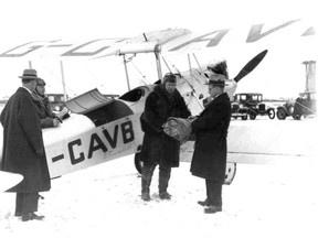 04 – Readying for takeoff north to Fort Vermilion from Edmonton Blatchford Field, January 2, 1929, “Wop” May accepts blanket-wrapped vials of diphtheria antitoxin from Dr. Malcolm Bow, Alberta deputy minister of health, for delivery to Dr. Harold Hamman to inoculate northern community against the contagious disease. Looking on (l-r) former Edmonton Mayor Ambrose Bury, and Vic Horner. The wrapped antitoxin with a charcoal heater travel in compartment behind two open cockpits of Avro-Avion bi-plane G-CAVB, operated by May and Horner’s Commercial Airways.