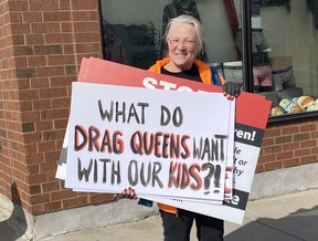 A protester, who wouldn't provide her name, carries a sign near The Ledge store in downtown Simcoe where Drag Story Time was held on Thursday afternoon.  KIM NOVAK PHOTO