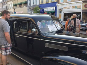 Andrew Dietze from Kincardine admires a 1939 LaSalle hearse, owned by John and Patti McCulloch of Durham, at a 2019 Kincardine cruise night. Photo by Barbara MacLeod.