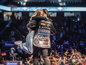 Gustafson celebrating his win on stage with his wife, right after the Kenora fisherman made history in front of a massive crowd. Photo courtesy of Bassmaster
