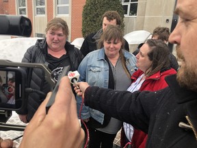 An emotional Kim Sweeney, centre, is approached by media outside the Sudbury courthouse on Wednesday after a jury found Robert Steven Wright guilty of her sister Renee’s murder. She is flanked by close friend Kelly Irvine, left, and cousin Jill Sauve.