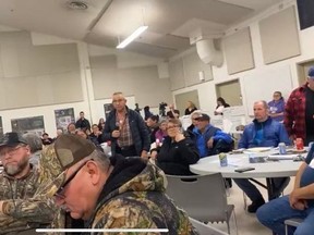 People at the Mamawi Community Hall in Fort Chipewyan, Alta. speak at a community meeting with Jamie Long, Imperial Oil's vice president of oilsands mining, on Wednesday, March 22, 2023. Screenshot of live footage provided by Athabasca Chipewyan First Nation
