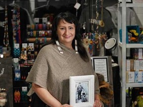Lisa Marie Bourque of Fort McMurray Métis Trading Post holds a photo of her ancestors near their trading post at Beaver Lake, Alta. Supplied Image/Lisa Marie Bourque
