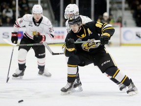 Sarnia Sting's Ty Voit (96) battles Owen Sound Attack's Tomislav Brennan (16) in the first period at Progressive Auto Sales Arena in Sarnia, Ont., on Friday, March 24, 2023. Mark Malone/Chatham Daily News/Postmedia Network