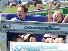 Cousins Travis Fraser, 8, of Orillia and Brinley Kaiser, 9, of Calgary ride the Scrambler at the Rotary Club of Wiarton's 82nd Village Fair on Sunday, August 4, 2019 in Wiarton, Ont. Rob Gowan/The Owen Sound Sun Times/Postmedia Network