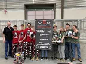 Tom MacIsaac, left, joins members of Father Mercredi High School's robotics team at VEX Robotics Provincials in Calgary. Image supplied by Tom MacIsaac