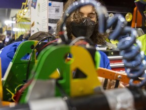 Aiden Scheben, 16, of St. Mary Catholic secondary school in Hamilton works on their team’s robot at the First Robotics competition held at Western University’s Thompson arena on Sunday March 19, 2023. There were 33 teams from across Southwestern Ontario and beyond. (Mike Hensen/The London Free Press)