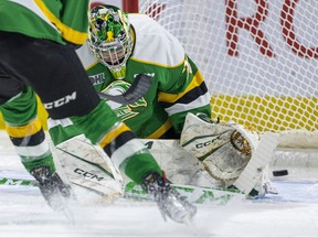 Brett Brochu of the London Knights couldn't squeeze his pads to stop Alex Christopoulos of the Windsor Spitfires from scoring his first of two goals in the first period of their OHL game at Budweiser Gardens in London on Friday March 24, 2023. Mike Hensen/The London Free Press/Postmedia Network