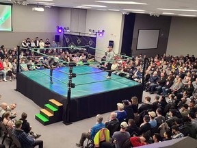 A wrestling arena surrounded by a crowd