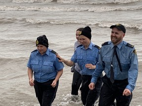 A group of OPP officers took the Polar Plunge at Turkey Point on Saturday while wearing their uniforms as part of an effort to raise funds for Special Olympics