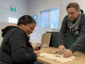 Saugeen Ojibway Nation Environment Office Archaeology Assistant Stephanie Roote (left) and Archaeology Coordinator Dr. Robert Martin (right) eagerly examine SON artifacts at the Environment Office near Wiarton. Photo submitted
