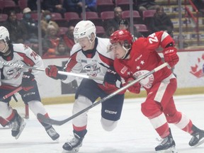Soo Greyhounds forward Justin Cloutier and Windsor Spitfires defenceman James Jodoin in first period OHL action at the GFL on Saturday night. Cloutier scored a goal in the second period, the Hounds snapping a five-game skid with an 8-2 win over the Spitfires.