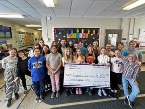 Westminster Public School students present a Cooperative Care Centre representative with a cheque for $350 to help those experiencing homelessness in Brockville.