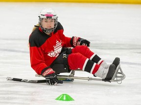 Hailey King dons her national team uniform during a sledge hockey practice. The 14-year-old was named to the Women's National Para Hockey Team, and is the youngest member on the roster.