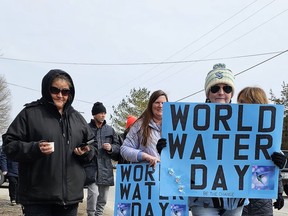 Participants carried signs and water as part of the Mohawks of the Bay of Quinte's Water Walk, which took place along Bayshore Road on Wednesday. The event, which was attended by approximately 40 supporters, was organized by MBQ's Water Department to honour Indigenous Peoples' relationship to water, to support the community and preservation of clean water. The event returned for the first time since before the Covid-19 pandemic and was organized by Mackenzie Brant and co-workers Liz Brant and Grant Barberstock and led by Dustin Kanonhsowanen Brant. The walk went from the Pow Wow Park to the Bay of Quinte at Ferry Lane where Dustin played a song, participants had the opportunity to say words or give thanks to the water, and then the group headed back to the Pow Wow Park. (Jan Murphy/Local Journalism Initiative Reporter)