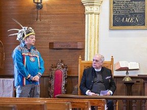 Canon Paul Wright (right), sub-dean of the Chapels Royal in the United Kingdom and Chaplain to the Monarch listens as Six Nations educator Michael Montour makes a thanksgiving address at the Mohawk Chapel in Brantford on Monday March 13, 2023 in Brantford, Ontario.  Wright also visited the former Mohawk Institute residential school during his private visit of learning and understanding.