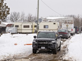 Police and fire investigation vehicles are parked in the laneway of a home on Mississaugas of the Credit First Nation following an early morning house fire Monday that claimed the life of a child.  OPP say two adults and four children were able to escape with minor injuries.