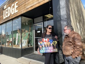 Robin Beazley holds a sign of support outside The Ledge in Simcoe on Thursday afternoon where Drag Storytime was held.