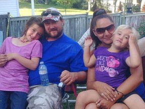 Marshall Howick and Norma White-Howick hold their children, Ava (left) and Alyssa.  Ten-year-old Ava died in a fire at the family's trailer on Monday in Mississauga of the Credit First Nation.