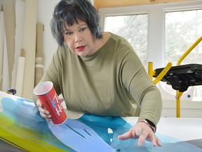 Chatham-Kent artist Vicki McFarland is shown at work on a painting. She is participating in the International Art and Found Day event this year on March 12. (Handout/Postmedia Network)