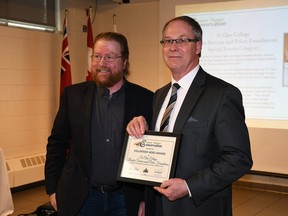 The St. Clair College border services and police foundations program received the Volunteer Hero Award from the Lower Thames Valley Conservation Authority during the authority's annual general meeting held March 2 at the Ridgetown Campus of the University of Guelph.  Shown here are outgoing conservation authority chair Trevor Thompson, left, and Mark Benoit, chair of the School of Academic Studies for St. Clair College at the Chatham campus.  (Tom Morrison/Chatham This Week)