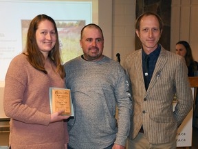 Kate Hoskins, left, and Chad Hoskins, right, received the Lower Thames Valley Conservation Authority's Most Generous Landowner award from Greg Van Every, conservation services coordinator, right, during the authority's annual general meeting March 2. (Tom Morrison/Chatham This Week)