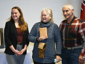 Alyssa Broeders, community conservation educator and urban stewardship technician with the Lower Thames Valley Conservation Authority, left, presents Sally Joyce and Alex Topol from Twin Dolphin/Strong House Canada Corp.  with the Most Dedicated Organization award at the authority's annual general meeting held March 2, 2023. (Tom Morrison/Chatham This Week)