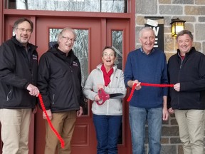 Laura's B&B operator Laura Peck and partner Sebastian Nussbaumer, from third from left, mark its grand opening with, from left, North Glengarry Couns. Jeff Manley and Brian Caddell, and Mayor Jamie MacDonald, on Thursday March 16, 2023 in Alexandria, Ont. Greg Peerenboom/Special to the Cornwall Standard-Freeholder/Postmedia Network