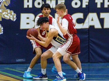 Bobcats Paulo Cuesta tries to escape the Cobras defence with the ball at Bow Valley High School in Cochrane on Thursday, March 2, 2023. The Bobcats beat the Cobras 76-69 in the RVSA play-off semifinal.