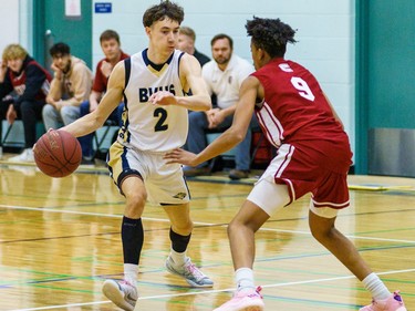 Bobcats Ethan Horb dribbles toward Cobras Will Jacques at Bow Valley High School in Cochrane on Thursday, March 2, 2023. The Bobcats beat the Cobras 76-69 in the RVSA play-off semifinal.