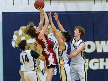 Cobras and Bobcats players battle for the ball at Bow Valley High School in Cochrane on Thursday, March 2, 2023. The Bobcats beat the Cobras 76-69 in the RVSA play-off semifinal.