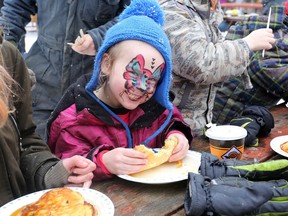 Six-year-old Adaline Lowe Gray chows down on some fresh pancakes during the first day of Maple Madness at Little Cataraqui Creek Conservation Area in Kingston on Saturday, March 4, 2023. The event is marking its 40th anniversary this year.