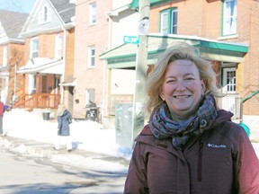 Sydenham District Coun. Conny Glenn at the corner of Aberdeen (sign missing) and William streets in Kingston on Thursday. In another week, the area next to Queen’s University will be full of St. Patrick’s Day parties.