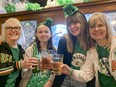 Three generations — grandmother Judy Dennee, granddaughters Lauren Riley and Emma Riley, and their mother Nicole Dennee — raise a glass to celebrate St. Patrick's Day at the Tir Nan Og in Kingston on Friday.