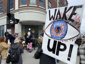 Environmentalists gather in front of the downtown Kingston branch of the Royal Bank of Canada to protest investment in fossil fuels on Tuesday.