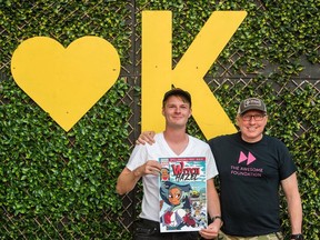 Colton Fox poses for a photo with his comic book project, Witch Hazel, and dean of Awesome Kingston Matt Dubblestein in July 2022.