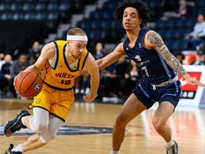 Queen's Gaels guard Scott Jenkins tries to get by Nicholas Bruyere of the University of Quebec at Montreal Citadins during the consolation final of the U Sports men's basketball championship tournament in Halifax on Sunday, March 12, 2023.