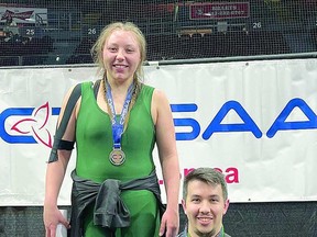 GOLD MEDAL WRESTLER Neveah Pine of White Pines, at the OFSAA gold medal podium, with Coach Basawa.