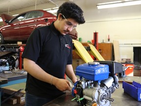 Northern Collegiate student Mohaimen Alameer works on an engine as a member of the Northern Eco-team.