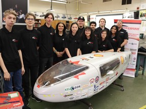 Sarnia Northern Eco-team members, from left, Bradley Crossett, Alex Neumann, William Nikel, teacher Jessie Donner, Elisabeth Mark, Kole Arnold, Victoria Flores, Mohaimen Alameer, Benjamin Neumann, Shayly Mount, Safia Deol and Teacher Doug McArthur stand next to the vehicle they will be taking to Indianapolis in April to compete in the Shell Eco-marathon.