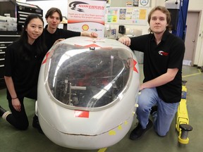 Student managers of this year's Sarnia Northern Collegiate Eco-team, from left, Elisabeth Mark, William Nikel and Benjamin Neumann are shown next to the vehicle the team will be taking to Indianapolis in April to compete in the Shell Eco-marathon.