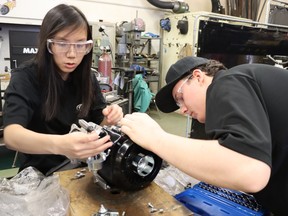 Sarnia Northern Collegiate students Shayly Mount, left, and Kole Arnold work on an engine as members of the Northern Eco-team. It’s travelling to Indianapolis in April to compete in the Shell Eco-marathon.