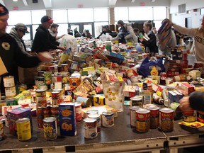 Volunteers sort Cyclone Aid food donations at St. Patrick's Catholic high school in Sarnia in this 2019 file photo.