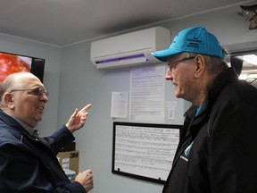 Jake VanRooyen, right, Bluewater Anglers' hatchery manager, explains to Sarnia-Lambton MPP Bob Bailey how their new heating and ventilation system, paid for through an Ontario Trillium Foundation grant, works during an open house Saturday.  Terry Bridge/Sarnia Observer/Postmedia Network