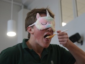 Braeden Babenko, a student at St. Patrick's Catholic high school in Sarnia, completes in a blind taste test in the school cafeteria during an event to recruit volunteers for Saturday's Cyclone Aid community good drive.