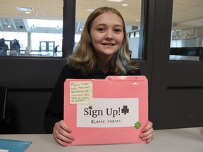 Esne Dreise, a Grade 9 student at St. Patrick's Catholic high school in Sarnia, signs up volunteers for Saturday's Cyclone Aid food drive.