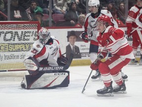 Soo Greyhounds forward Justin Cloutier skates in front of Windsor Spitfires goaltender Joey Costanzo. The Spits keeper stopped 33 shots in a 3-0 victory for the Spitfires.
