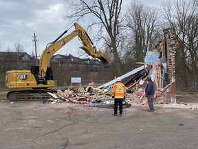 Workers from Jess Morris Trucking & Excavating of Simcoe demolished a vacant building in the municipal parking lot at 8 Argyle Street in Simcoe on Monday. SIMCOE REFORMER PHOTO