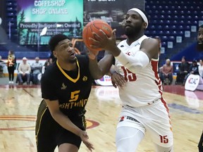 JD Miller, right, of the Sudbury Five, drives to the basket against Justin Jackson, of the London Lightning, during basketball action at the Sudbury Community Arena in Sudbury, Ont. on Thursday March 2, 2023. John Lappa/Sudbury Star/Postmedia Network