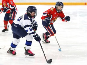 Cameron Bumbacco, left, of Sudbury U13A, attempts to evade Spencer Cortes, of Manitoulin Panthers U13B, during action at the Nickel District Hockey League playoffs at the Gerry McCrory Countryside Sports Complex in Sudbury, Ont. on Friday March 3, 2023. John Lappa/Sudbury Star/Postmedia Network